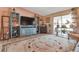 Living room with large window, tv and shelving at 13635 E Bates Ave # 406, Aurora, CO 80014