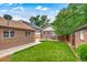 Spacious backyard with lush green grass, patio, and mature trees at 840 S Corona St, Denver, CO 80209