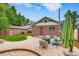 Backyard showcasing a paved patio with a fire pit and outdoor seating area at 840 S Corona St, Denver, CO 80209