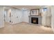 Basement room featuring a brick fireplace, neutral carpet, and a bright airy feel at 840 S Corona St, Denver, CO 80209