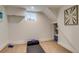 Basement workout area with exercise mat, storage shelves, and a window for natural light at 840 S Corona St, Denver, CO 80209