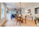 Open dining room featuring hardwood floors, a modern light fixture, and a view of the living area at 840 S Corona St, Denver, CO 80209