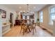 Stylish dining room with a glass table and views of the kitchen bar area at 840 S Corona St, Denver, CO 80209