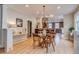Bright dining area with hardwood floors, leading to an open kitchen and living spaces at 840 S Corona St, Denver, CO 80209
