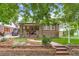 Charming brick home with a well-manicured front yard and inviting porch at 840 S Corona St, Denver, CO 80209