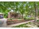 Charming brick home with a well-maintained front yard, mature trees, and inviting curb appeal at 840 S Corona St, Denver, CO 80209