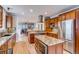 Open kitchen with stainless appliances, center island, and seamless flow to the dining and living areas at 840 S Corona St, Denver, CO 80209