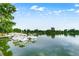 Calm lake with paddle boats docked, surrounded by lush greenery at 840 S Corona St, Denver, CO 80209