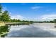 Calm lake view with a dock and boat, surrounded by lush trees at 840 S Corona St, Denver, CO 80209