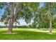 Lush green park with mature trees, a volleyball net, and sunny skies at 840 S Corona St, Denver, CO 80209