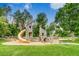 Community playground with wooden play structures and a yellow slide at 840 S Corona St, Denver, CO 80209