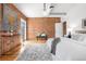Spacious bedroom with exposed brick wall and wood floors at 624 E 18Th Ave # 3, Denver, CO 80203