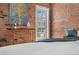Bedroom with exposed brick wall, view of a balcony, and artistic decor at 624 E 18Th Ave # 3, Denver, CO 80203