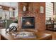 Living room with a brick fireplace, wood floors, and modern decorations at 624 E 18Th Ave # 3, Denver, CO 80203
