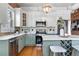 Modern kitchen features stainless appliances, white cabinets, a central island and quartz countertops, creating an open space at 624 E 18Th Ave # 3, Denver, CO 80203