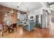 Kitchen with stainless appliances, hardwood floors, an island with seating, and brick accent wall at 624 E 18Th Ave # 3, Denver, CO 80203