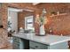 Open-concept kitchen featuring a center island, brick wall accents, and a view into the living room at 624 E 18Th Ave # 3, Denver, CO 80203