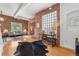 Bright living room featuring brick accent walls, an office nook, and wood floors at 624 E 18Th Ave # 3, Denver, CO 80203