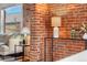 Bright living room featuring brick accents, a side table with lamps, and natural light at 624 E 18Th Ave # 3, Denver, CO 80203