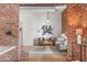 Cozy living room with brick accents, hardwood floors, modern furniture, and view of the dining area at 624 E 18Th Ave # 3, Denver, CO 80203