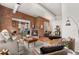 Open-concept living area connects a modern kitchen with island to cozy fireplace and seating, all with exposed brick at 624 E 18Th Ave # 3, Denver, CO 80203