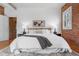 Bedroom with hardwood floors, neutral walls, and a large bed with plush pillows at 624 E 18Th Ave # 3, Denver, CO 80203