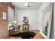 Office with brick accent wall, hardwood floors, and modern decorations at 624 E 18Th Ave # 3, Denver, CO 80203