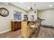 Finished basement includes bar with granite counters, pendant lighting, and wood-look flooring at 2601 S Kipling Ct, Lakewood, CO 80227