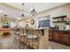 Finished basement featuring a wooden bar with granite countertop and pendant lighting at 2601 S Kipling Ct, Lakewood, CO 80227