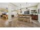 Finished basement featuring a bar area with seating, bar, and storage cabinets at 2601 S Kipling Ct, Lakewood, CO 80227