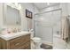 Bathroom featuring a walk-in shower and a wood vanity with solid surface countertops at 2601 S Kipling Ct, Lakewood, CO 80227