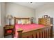 Bedroom featuring a wood-framed bed, side tables, and a dresser at 2601 S Kipling Ct, Lakewood, CO 80227