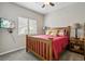 Cozy bedroom with wood-framed bed, side tables, and a window providing natural light at 2601 S Kipling Ct, Lakewood, CO 80227