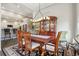 Formal dining area showcasing a large dining table set with a china cabinet and view to kitchen at 2601 S Kipling Ct, Lakewood, CO 80227