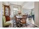 Elegant dining room featuring a large table with seating for six and a beautiful display cabinet at 2601 S Kipling Ct, Lakewood, CO 80227