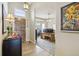 Inviting entryway with wood-look tile flooring, leading to a home office space at 2601 S Kipling Ct, Lakewood, CO 80227