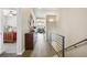 Hallway with railing, hardwood floors and view into the living spaces at 2601 S Kipling Ct, Lakewood, CO 80227