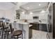 Stylish kitchen features a breakfast bar, pendant lighting and modern appliances at 2601 S Kipling Ct, Lakewood, CO 80227