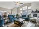 Comfortable living room featuring a stone fireplace, large windows, and hardwood flooring at 2601 S Kipling Ct, Lakewood, CO 80227