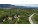 Breathtaking aerial view showcasing a lush landscape and a charming home nestled among the trees at 8821 S Perry Park Rd, Larkspur, CO 80118