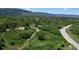Sprawling mountain view property with a charming home surrounded by lush greenery and mature trees at 8821 S Perry Park Rd, Larkspur, CO 80118