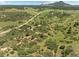 Breathtaking aerial shot showcases rolling green hills, winding roads, and scattered homes at 8821 S Perry Park Rd, Larkspur, CO 80118