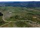 Expansive aerial shot showcasing a beautiful large parcel with roads, trees and rolling hills at 8821 S Perry Park Rd, Larkspur, CO 80118