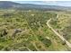 Expansive aerial view captures the property's vastness with winding roads, trails, and lush foliage at 8821 S Perry Park Rd, Larkspur, CO 80118