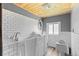 Bathroom with a walk-in tub, white subway tile, and wood-look flooring at 8821 S Perry Park Rd, Larkspur, CO 80118