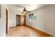 Bedroom with ceiling fan, hardwood floors, and a window offering natural light at 8821 S Perry Park Rd, Larkspur, CO 80118