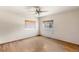 Bright bedroom featuring a ceiling fan and large windows with wooden blinds at 8821 S Perry Park Rd, Larkspur, CO 80118