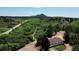 Scenic view of a house nestled amidst green landscape with a mountain backdrop, offering a serene setting at 8821 S Perry Park Rd, Larkspur, CO 80118