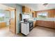 Functional kitchen featuring wooden cabinets, vintage appliances, and a window with scenic views at 8821 S Perry Park Rd, Larkspur, CO 80118