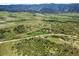 Property and adjacent land showing defined white border; lush green landscape with mountain views and winding road at 8821 S Perry Park Rd, Larkspur, CO 80118